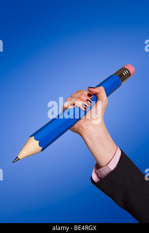 Big blue pencil isolated on a blue background Stock Photo