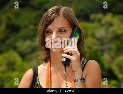 Young woman listening to an infophone on the nature trail in the Daintree Rainforest Environmental Centre, Daintree National Pa Stock Photo