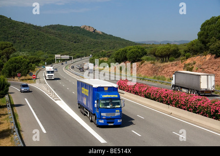 Vehicles travel on the A8 autoroute, La Provencale, in Southern France. Stock Photo