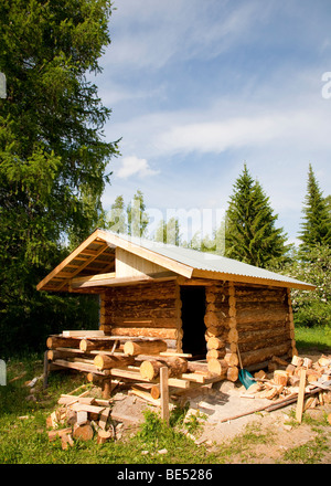 Log cabin made of barked spruce logs under construction , Finland Stock Photo