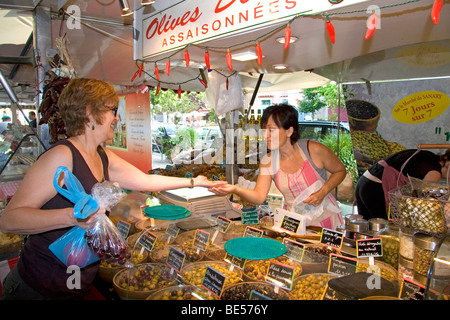 Customer purchasing produce from an outdoor market vendor in Sanary sur Mer, Southern France. Stock Photo