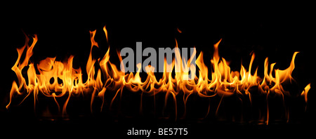 Tongues of fire in a panoramic view over a black background. Stock Photo