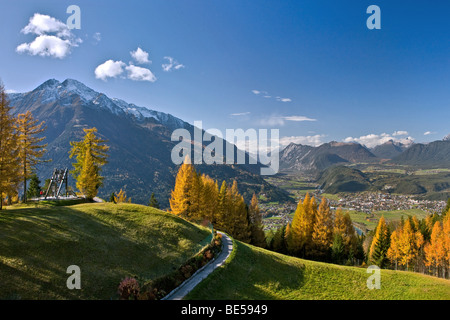 Friedensglocke, Peace Bell, in Moesern, larch trees in autumn, Hocheder in the Stubai Alps, overlooking the Inntal valley, Telf Stock Photo
