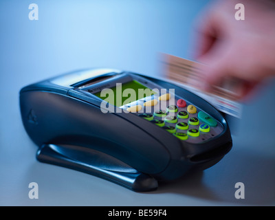 Swiping card through an EFTPOS machine. Stock Photo