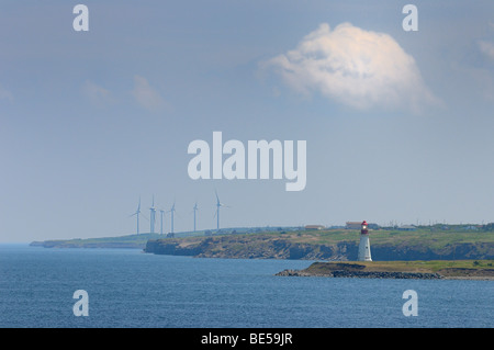 Low Point lighthouse with New Waterford wind turbines on Cape Breton Island Nova Scotia Stock Photo