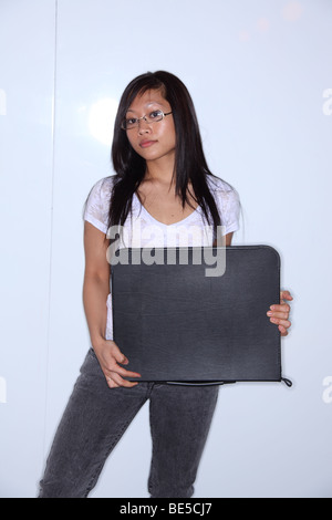 Asian woman holding portfolio Stock Photo