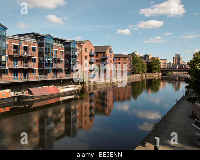 River Aire in Leeds UK with apartments and longboats Stock Photo