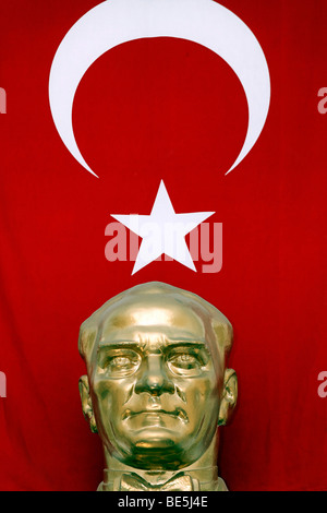 Golden bust of Mustafa Kemal Atatuerk in front of Turkish flag, Istanbul, Turkey Stock Photo