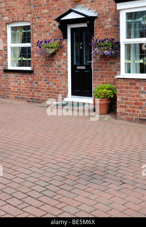 a front garden paved over with block paving stones, uk Stock Photo