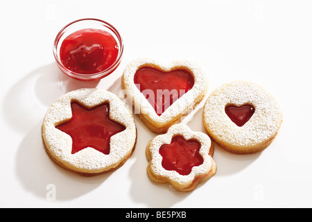 Short pastry jam biscuits, strawberry jam in a glass bowl Stock Photo