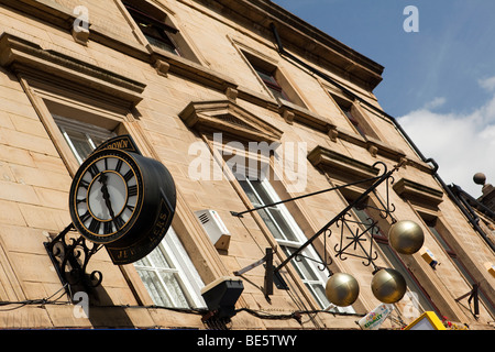 UK, England, Yorkshire, Keighley, East Parade, three brass balls hanging outside pawnbrokers shop Stock Photo