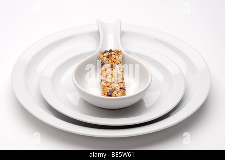 colorful granola bar on bland white serving dishes Stock Photo