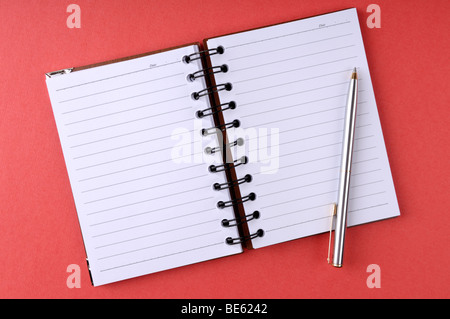 Open notepad with a pen Stock Photo