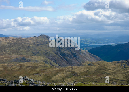 The Langdale Pikes (Pike o'Stickle, Harrison Stickle, Loft Crag) with Lake Windermere in the distance as viewed from Allen Crags, Lake District, Cumbr Stock Photo