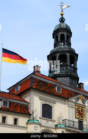 City Hall tower with chimes and fluttering flag of Germany, Lueneburg, Lower Saxony, Germany, Europe Stock Photo