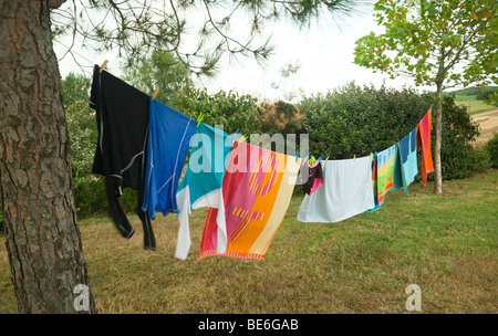 Colourful washing hanging out drying on a washing line outdoors UK Stock Photo