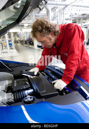 Audi employee doing final inspections of the Audi R8 sports car at the finish line in the Audi R8 assembly hall, Baden-Wuerttem Stock Photo