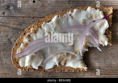Slice of bread with lard and roasted and red onions Stock Photo