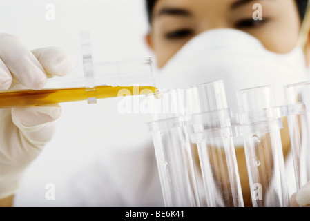 Laboratory technician transferring liquid to test tube Stock Photo