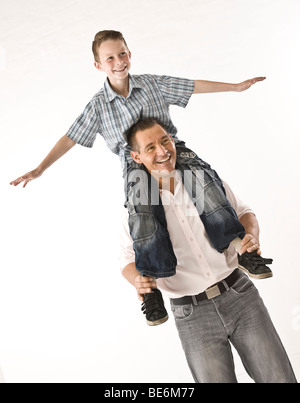 Father carrying his son on his shoulders Stock Photo