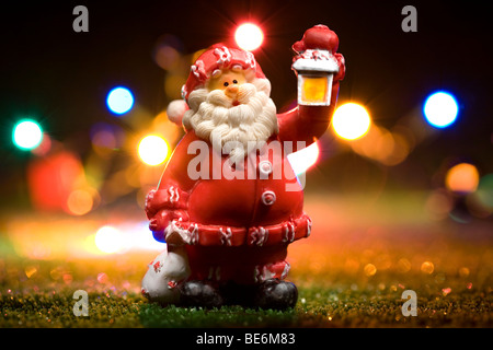 santa claus figurine holding lantern at night Stock Photo