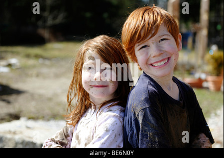 Children, totally covered in mud, dirty, wild, untypical girl Stock Photo