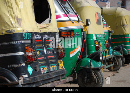 auto-rickshaws parked at roadside, Agra, India Stock Photo