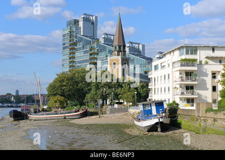 St Mary's Battersea, parish church, London, England, UK, on the banks of the river Thames, between contemporary buildings Stock Photo