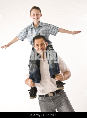 Father carrying his son on his shoulders Stock Photo
