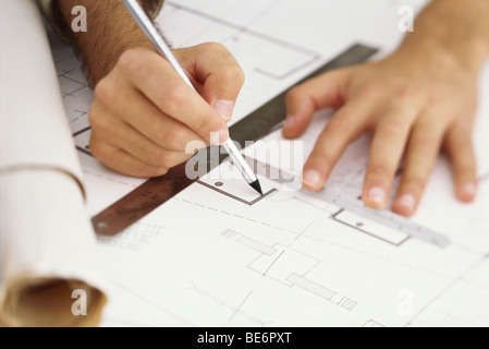 Architect editing blueprint, close-up Stock Photo