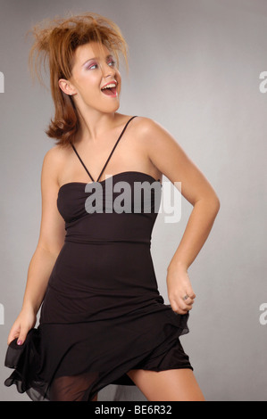 Woman in a black dress dancing at a silent disco, SWN festival, Cardiff ...