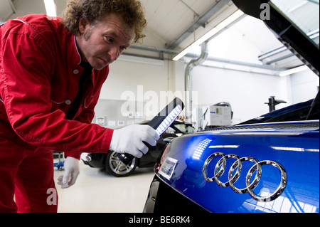 Audi employee doing final inspections of the Audi R8 sports car at the finish line in the Audi R8 assembly hall, Baden-Wuerttem Stock Photo