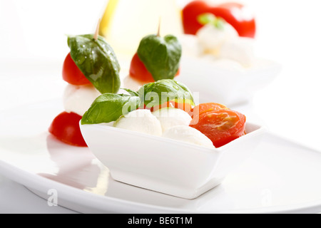 Tomato-mozarella sticks with basil in a bowl Stock Photo