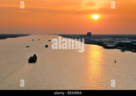 Transport boats in the last evening light during sunset on the Mekong River, My Tho, Mekong Delta, Vietnam, Asia Stock Photo