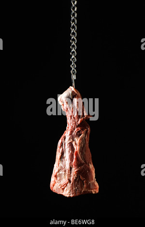 Steak hanging from meat hook Stock Photo