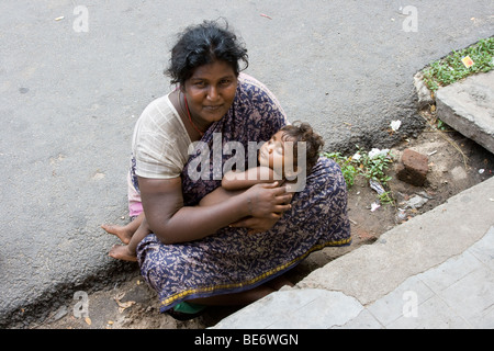Woman with baby begging in the street in Pondicherry India Stock Photo