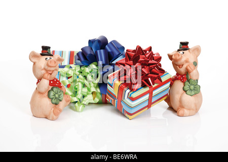 Presents with ribbons and lucky pigs Stock Photo