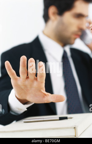 Businessman on phone call, making stop gesture with hand Stock Photo
