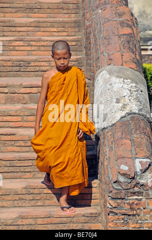 Novice on the stairway to the crypt, Great Chedi Chaya Mongkol, Wat Yai Chai Mongkon, Ayutthaya, Thailand, Asia Stock Photo