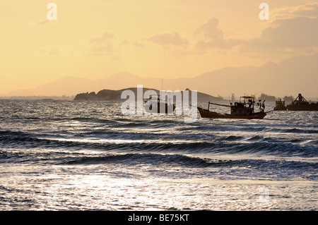 Fishing boats at sunset in the bay of Ke Ga, Vietnam, Asia Stock Photo