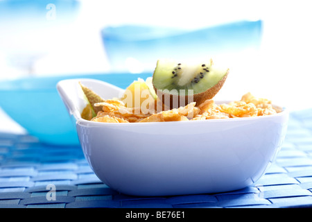 Cornflakes with kiwi and pineapple slices Stock Photo