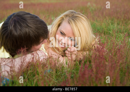 Young couple in love, lying in a meadow Stock Photo