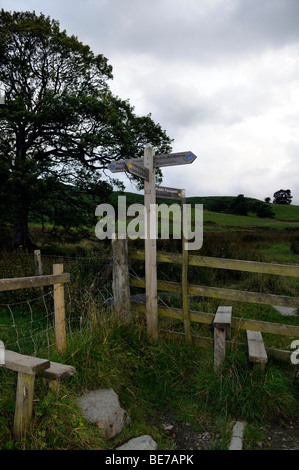 A signpost with four directions on the hiking paths of the Lake District. Stock Photo
