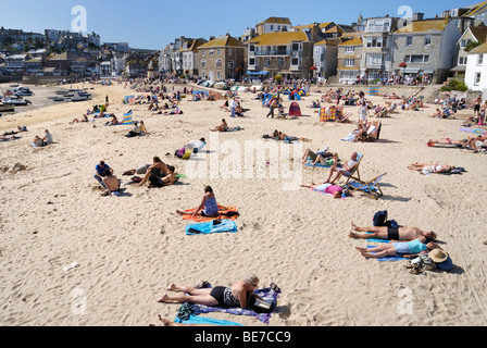 Sunbathers on a sandy beach in St Ives harbour Stock Photo