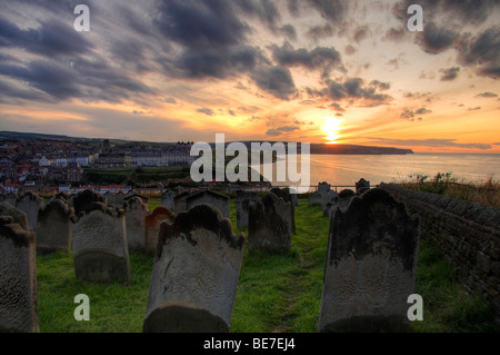 Sunset over Whitby coast, with St Marys churchyard in the foreground, North Yorkshire, England, UK Stock Photo