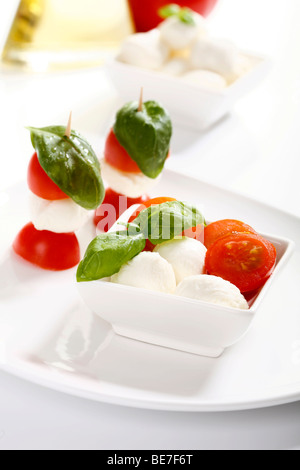 Tomato-mozarella sticks with basil in a bowl Stock Photo