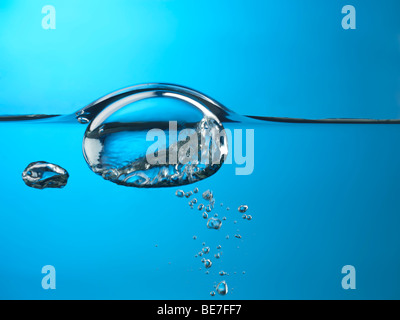 Oxygen bubble rising to the surface of water Stock Photo