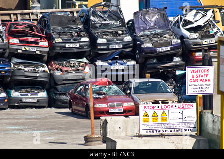 Car scrapyard, and worrying sign, Salford, Greater Manchester, UK. Stock Photo