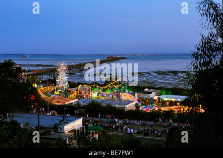 SOUTHEND-ON-SEA, ESSEX, UK - AUGUST 28, 2009:  View of Southend Pier and Adventure Island at night with crowds waiting for torchlight carnival parade Stock Photo