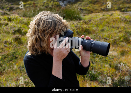 Female photographer taking photograph. Stock Photo